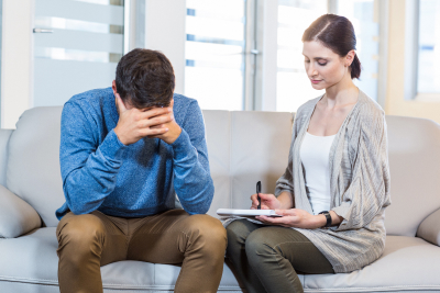 a depressed man talking to a psychiatrist